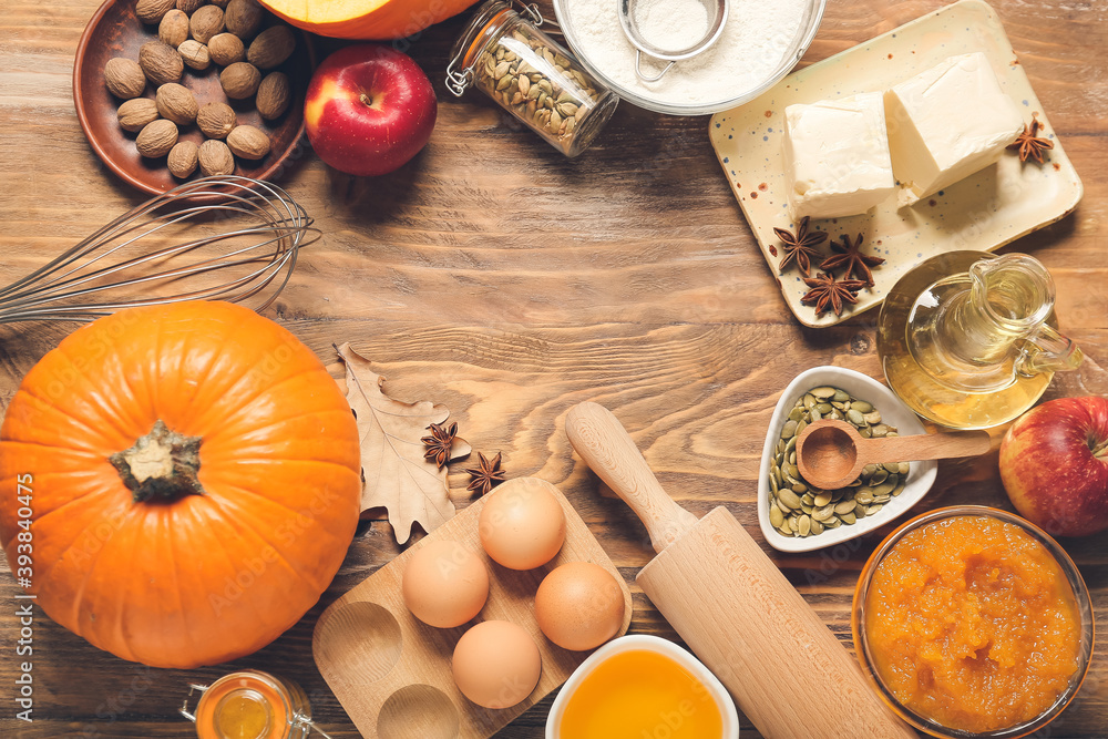 Frame made of ingredients for preparing pumpkin pie on wooden background Frame made of ingredients for preparing pumpkin pie on wooden background