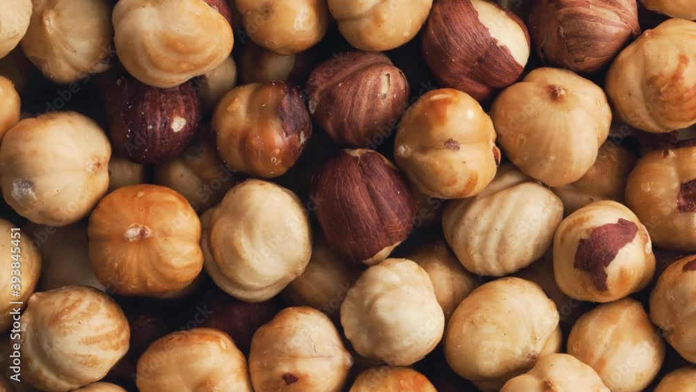 Rotating heap of peeled roasted hazelnuts. View from above. Rotating heap of peeled roasted hazelnuts. View from above.