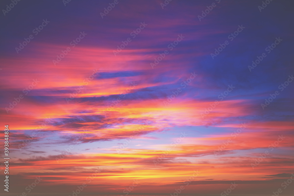 Colorful blazing cloudy sky at sunset. Gradient color. Sky texture, abstract nature background
