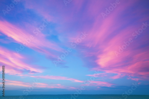Seascape. Seashore at dramatic blazing sunset. Landscape with sea and bright evening cloudy sky