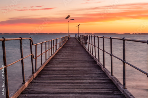 The Robe wooden jetty with orange glow at sunset located in South Australi on November 9th 2020