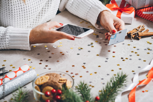 Woman shopping online for Christmas on smartphone