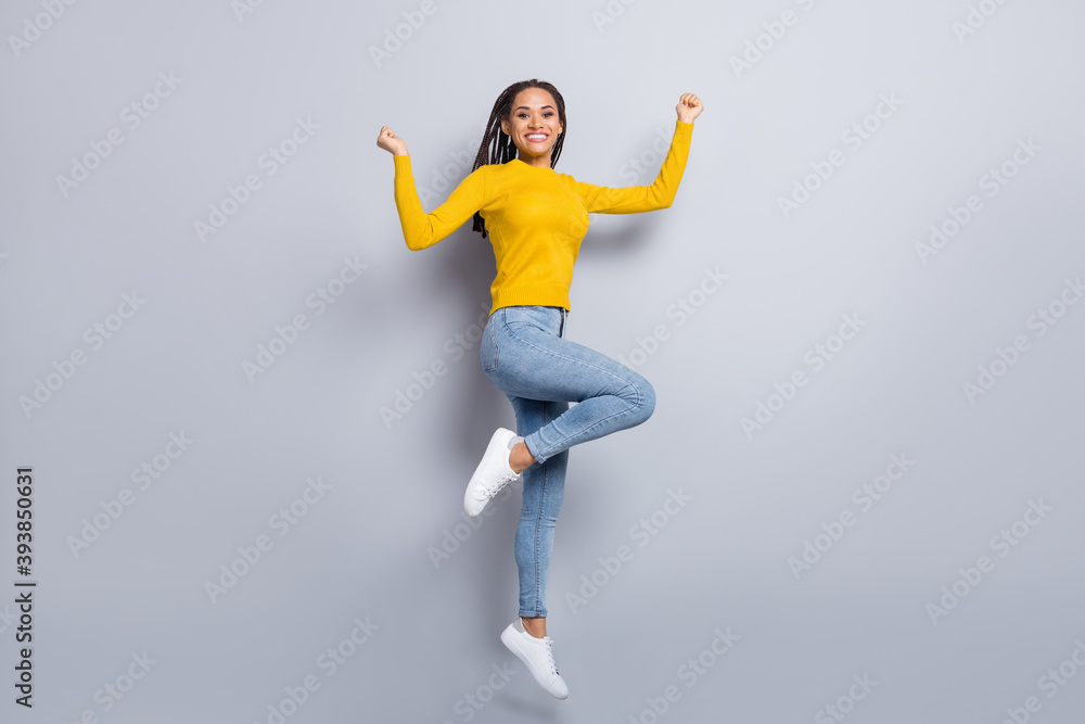 Full size photo of young active african woman happy positive have fun enjoy jump wear sweater isolated over grey color background