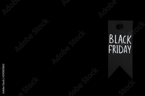 Tag with phrase Black Friday on dark background, space for text