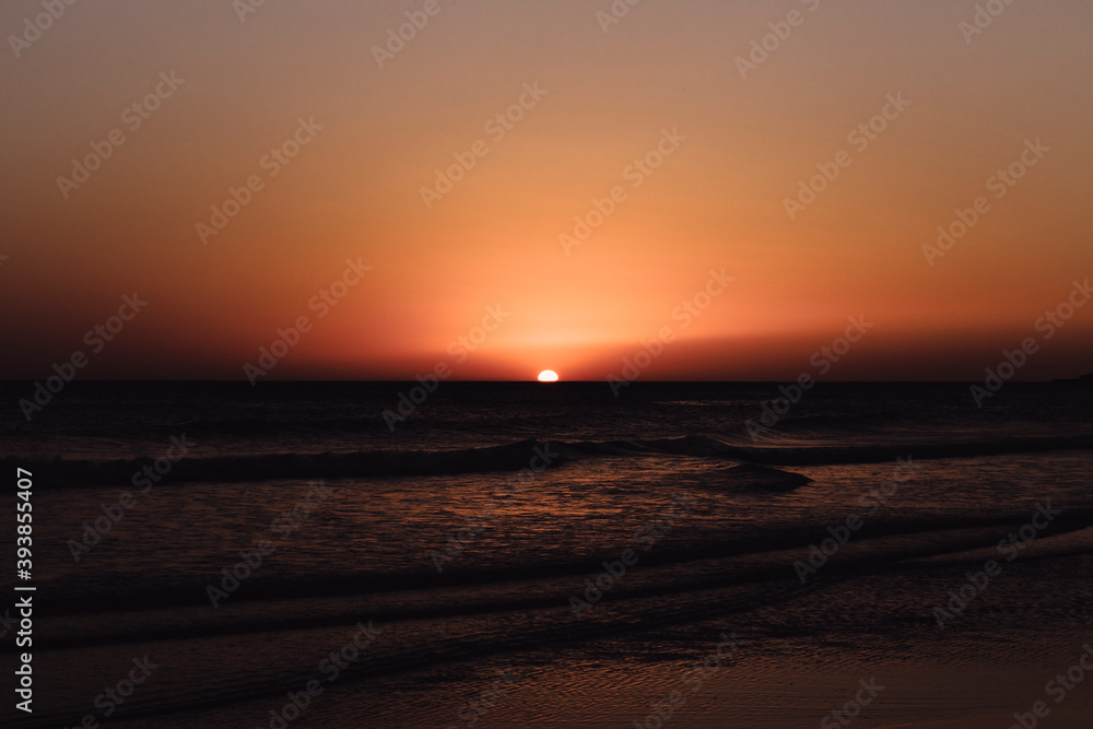 sunset on the beach with waves sunset on the beach with waves