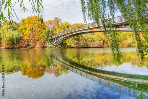 Beautiful autumn landscape with a bridge and reflection in the Kharkov river