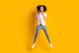 Photo portrait full body view of girl with spread legs hands near face open mouth jumping up isolated on vivid yellow colored background