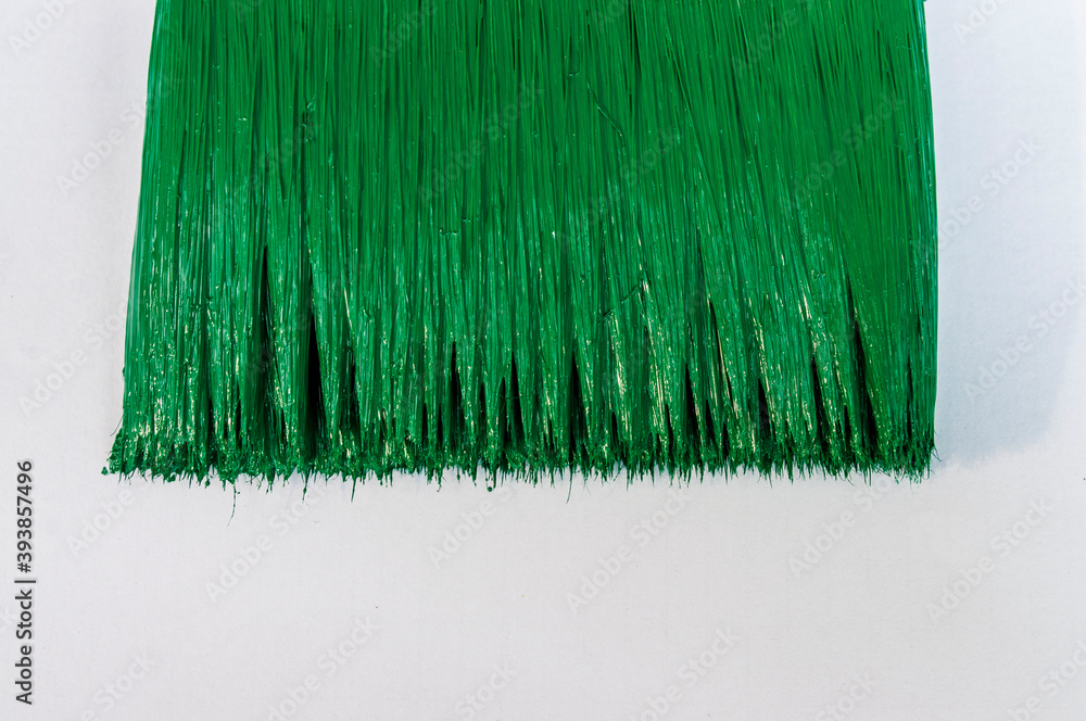 Green paint brush on white background
