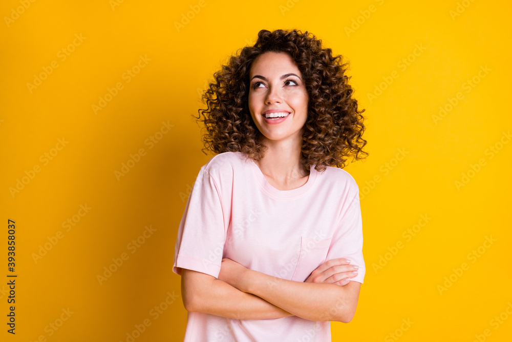 Photo of young curious dreamy girl crossed hands look empty space isolated over yellow color background Photo of young curious dreamy girl crossed hands look empty space isolated over yellow color background
