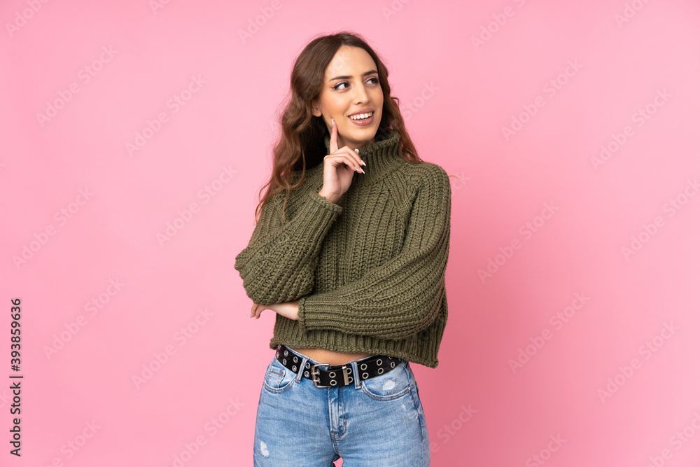 Young woman over isolated pink background thinking an idea while looking up Young woman over isolated pink background thinking an idea while looking up