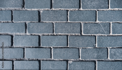 Walkway of dark gray stone tiles close-up