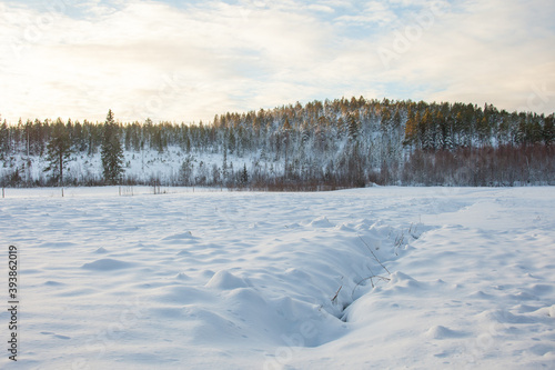 Snow covered meadow with mountain in the background © Ida Wastensson