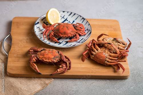 Deliciously cooked crabs on plates with lemons and herbs