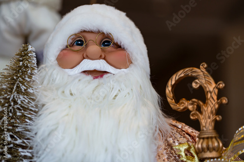 Santa Claus and Christmas tree toy on blurred background. Merry Christmas and Happy new Year. Cute Santa Claus toy close up, copy space for text, home decor.