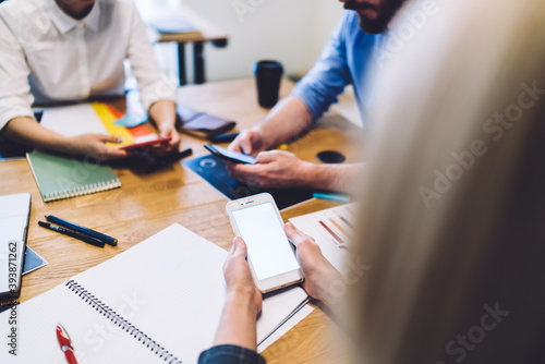 Anonymous coworkers using smartphones at office