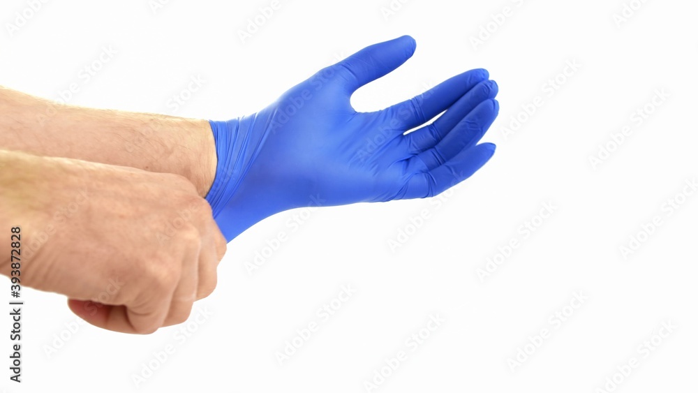 Putting On Protective Blue Surgical Gloves on White Background POV