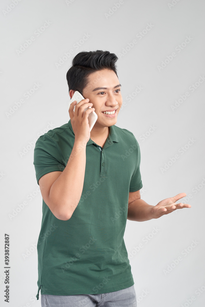 Young handsome man talking on cellphone, excited, rejoicing, isolated on white background. Young handsome man talking on cellphone, excited, rejoicing, isolated on white background.