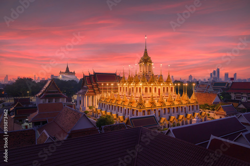 Loha Prasat Wat Ratchanatda and Golden Mountain pagoda, a buddhist temple or Wat Saket with skyscraper buildings in Bangkok Downtown, urban city, Thailand. Thai Landmark. Architecture. photo