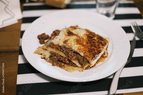 Piece of meat lasagne on the plate.