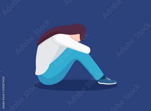 Sad lonely woman in depression. Young unhappy girl sitting and hugging her knees. Depressed teenager