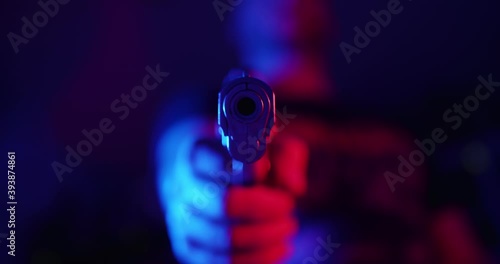 Man pointing a gun to the camera