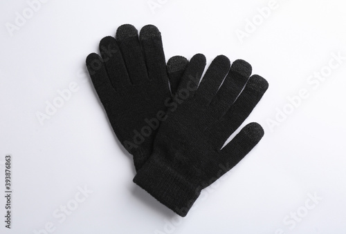 Pair of stylish woolen gloves on white background, flat lay