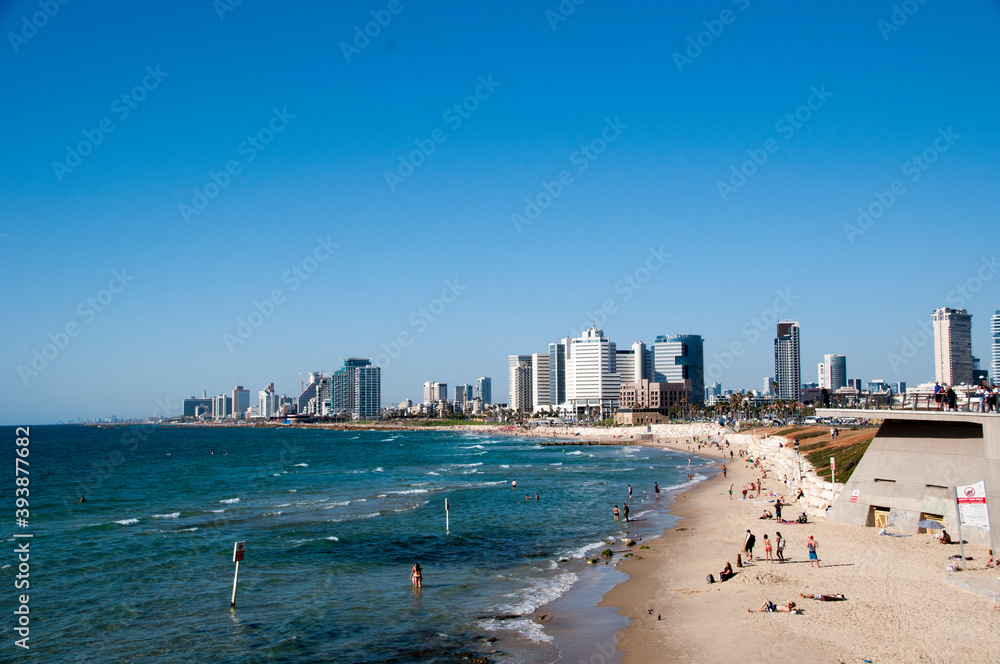 View of the city of Tel Aviv, and the beach of the Mediterranean Sea on a summer day View of the city of Tel Aviv, and the beach of the Mediterranean Sea on a summer day