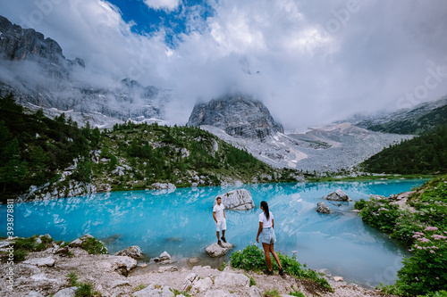 Couple visit the blue green lake in the Italian Dolomites,Beautiful Lake Sorapis Lago di Sorapis in Dolomites, popular travel destination in Italy. Europe photo