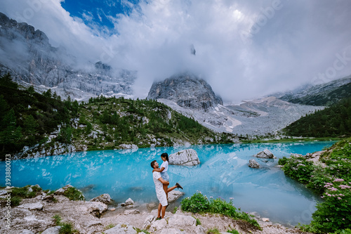 Couple visit the blue green lake in the Italian Dolomites,Beautiful Lake Sorapis Lago di Sorapis in Dolomites, popular travel destination in Italy. Europe photo