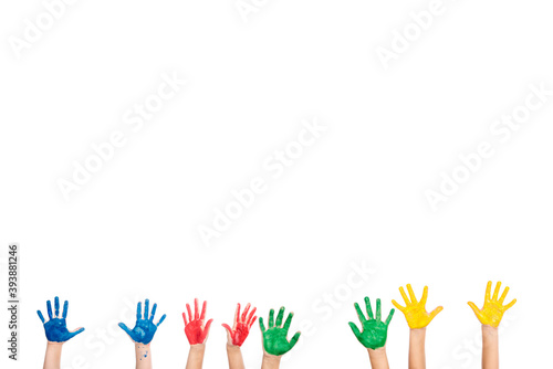 Cropped view of hands of kids in colorful paint isolated on white