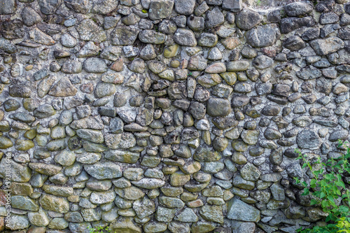 Texture of an old ancient weathered stone wall, background image.