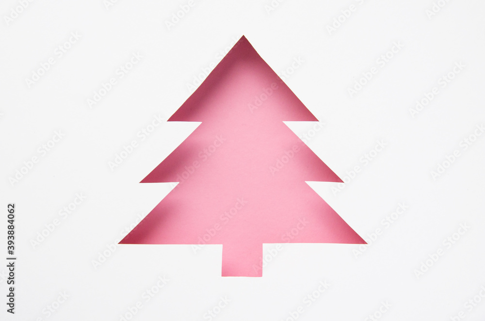 Greeting card with a Christmas tree cut out of paper. Silhouette of a pink fir tree. Happy new year. Merry christmas. 2021 Greeting card with a Christmas tree cut out of paper. Silhouette of a pink fir tree. Happy new year. Merry christmas. 2021