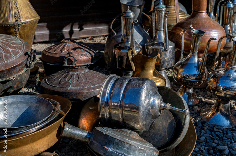 Close up of antique brass jugs and dishes