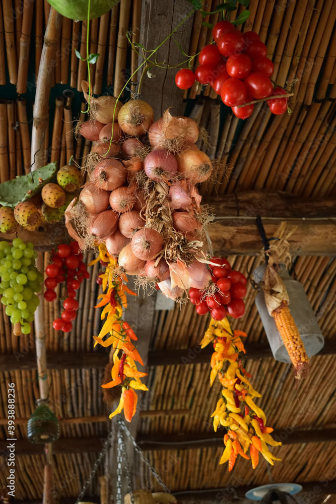Various Vegetables hanging from a roof