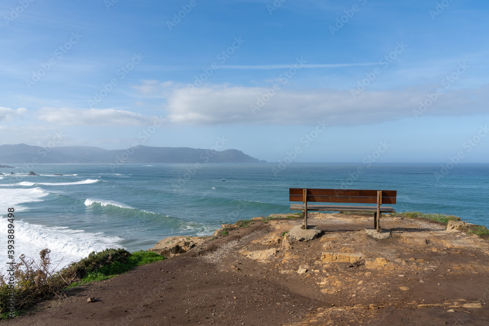 scenic viewpoint with wooden bench on beautiful ocean coast with high cliffs and big waves scenic viewpoint with wooden bench on beautiful ocean coast with high cliffs and big waves