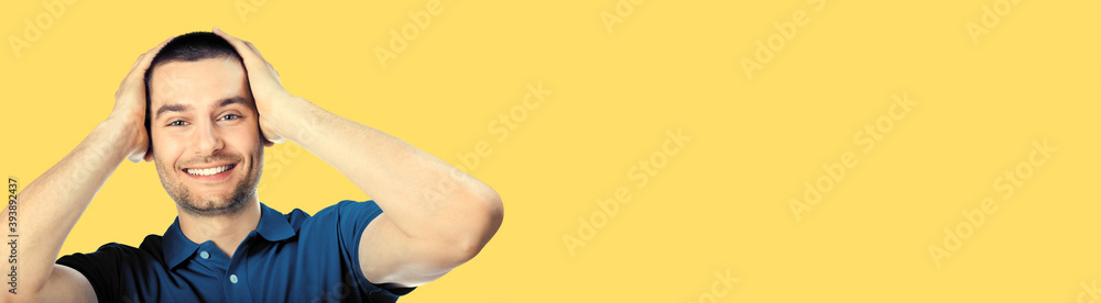 Unbeliveable good news! Very happy man, isolated over yellow color background. Emotions and success concept. Excited male model with rise up hands, blue casual clothing at studio portrait. Copy space. Unbeliveable good news! Very happy man, isolated over yellow color background. Emotions and success concept. Excited male model with rise up hands, blue casual clothing at studio portrait. Copy space.