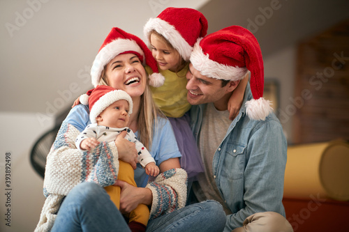 happy young family gathered for christmas, enjoying together. Corona, covid concept. © luckybusiness