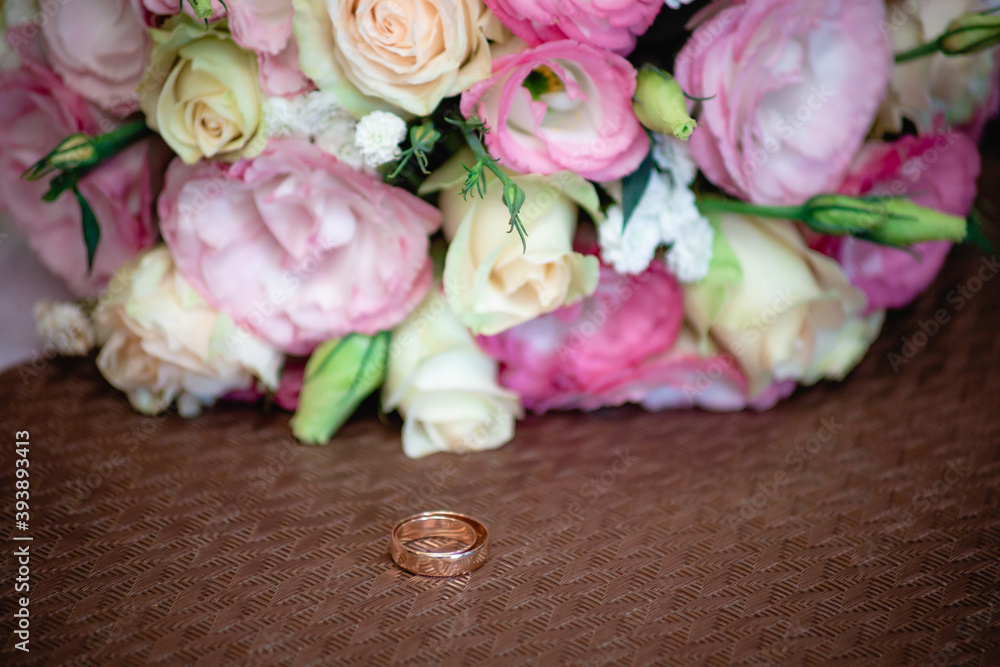 Wedding rings on the background of the bouquet