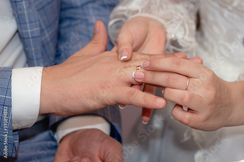 Hands. Newlyweds exchange wedding rings