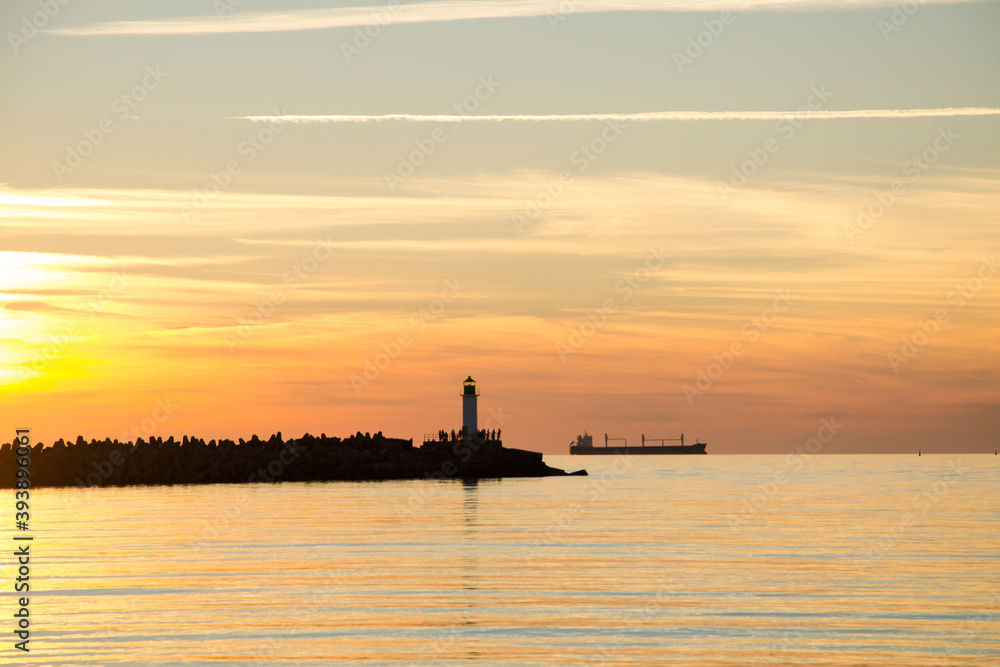 sunset lighthouse boat sea