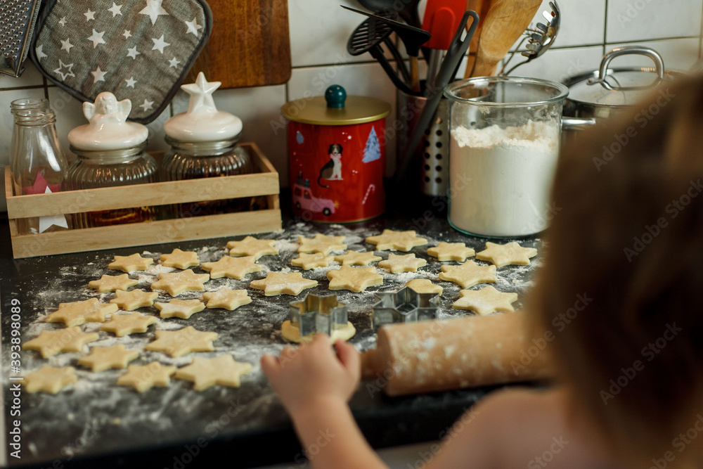 little girl bakes cookies in the form of stars. Christmas cookies. little girl bakes cookies in the form of stars. Christmas cookies.