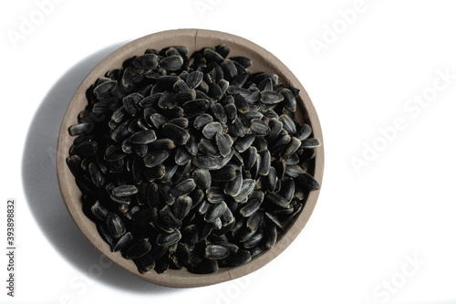 Sunflower seeds in a plate on a white background