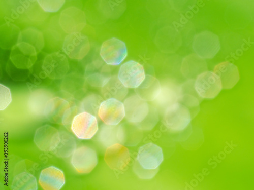 abstract bokeh blur background the multi color heptagon snape of bright water drop reflection on green shade space for festival and celebration