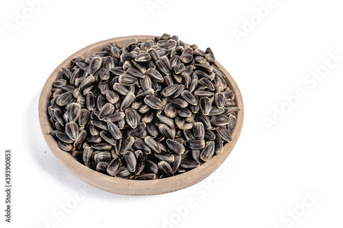Sunflower seeds in a plate on a white background