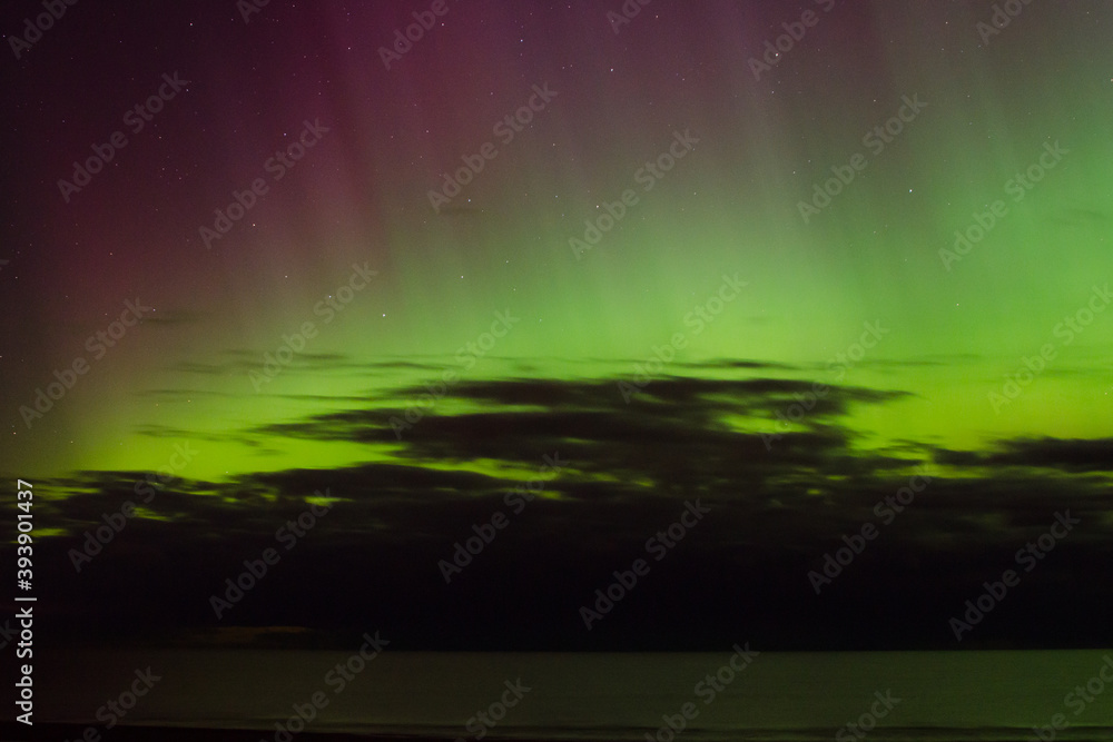 green and violet aurora borealis by the sea green and violet aurora borealis by the sea