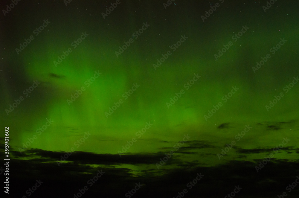 green aurora borealis by the sea 