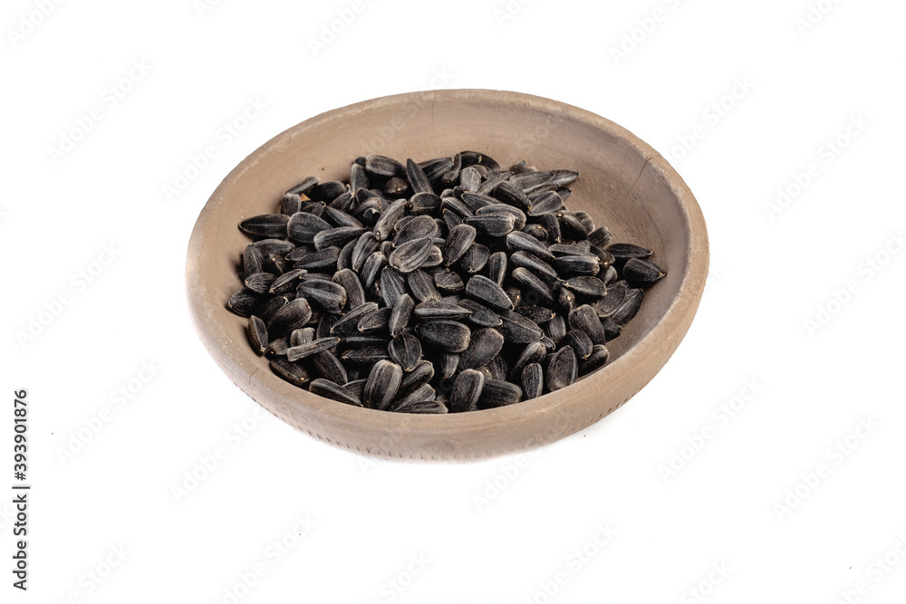 Sunflower seeds in a plate on a white background Sunflower seeds in a plate on a white background