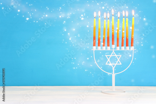 Religion image of jewish holiday Hanukkah background with menorah (traditional candelabra) and candles