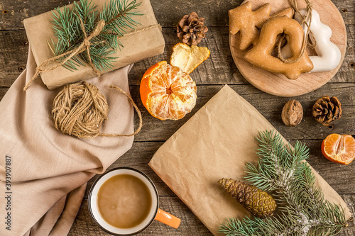 New Year's composition. Gingerbreads, gift wrapped in paper and Christmas decorations on a wooden background. Christmas, winter, new year concept. Flat lay, top view