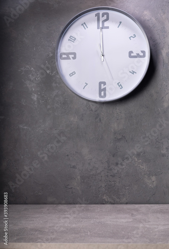 wall clock at concrete or putty background